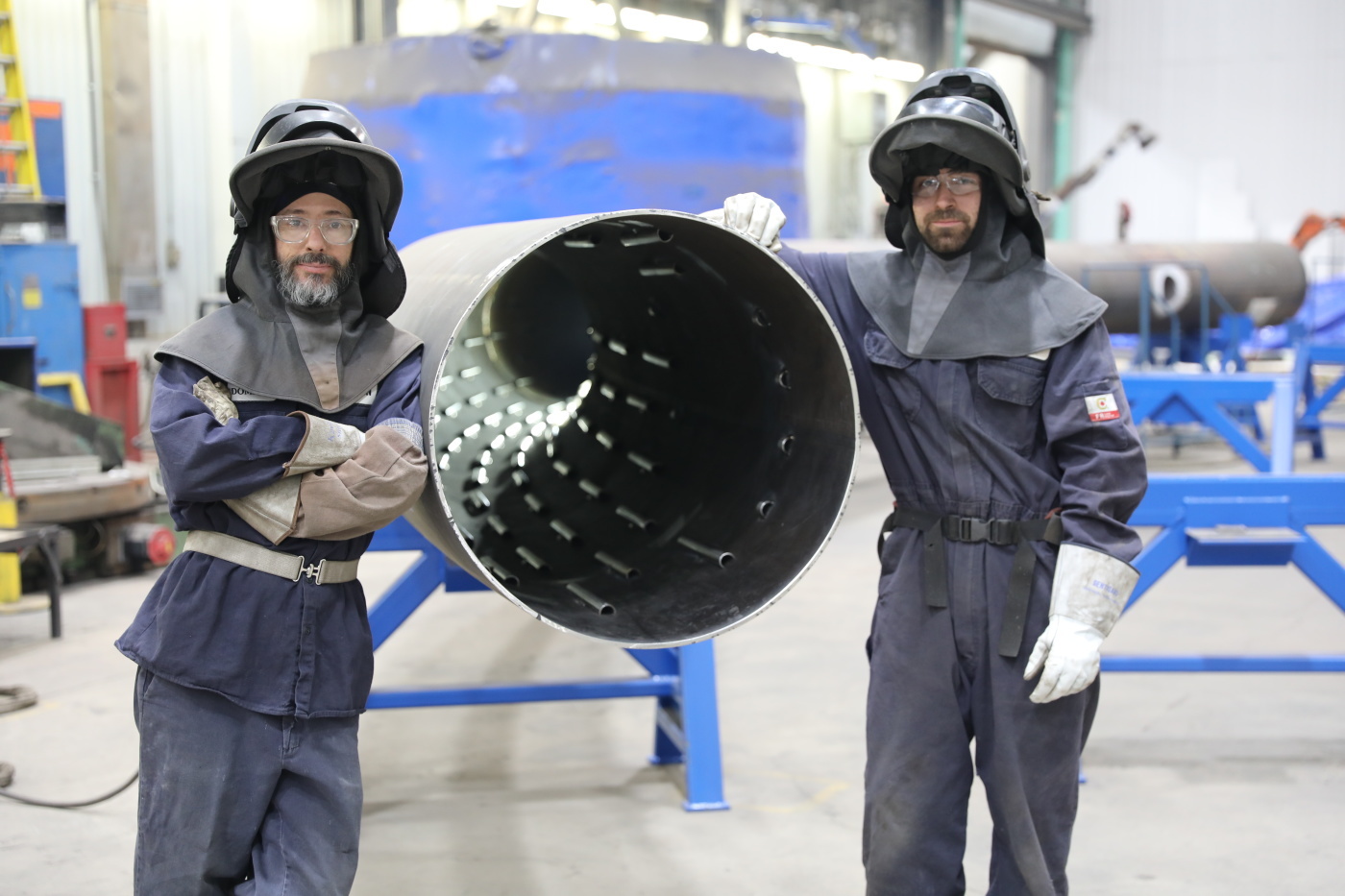 Welders working on a steel artistic ring